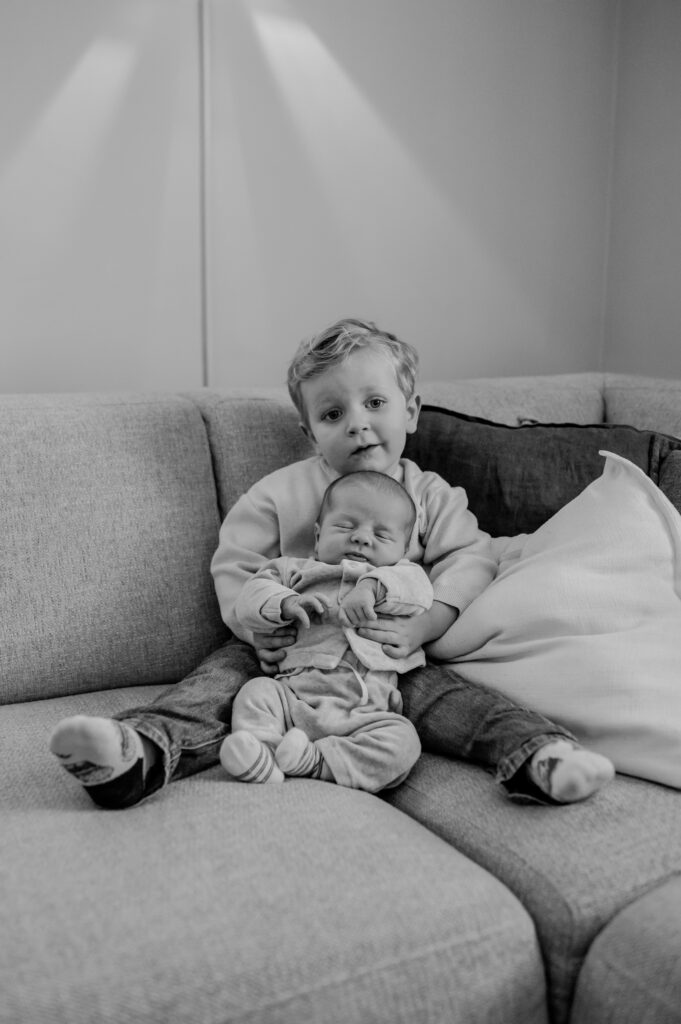Twee broertjes poseren samen tijdens een newbornshoot aan huis